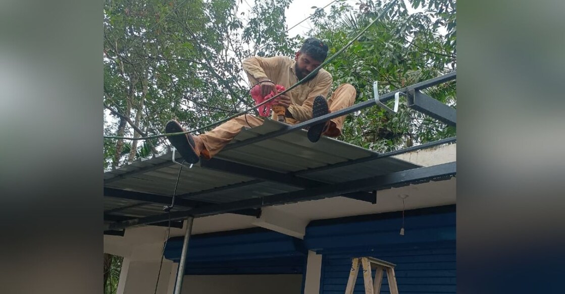 Jince Jose at work, welding on a rooftop. Photo: Special Arrangement.
