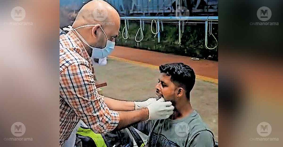 Dr P S Jithin attends to a passenger who was unable to close his mouth after yawning. Photo: Special arrangement