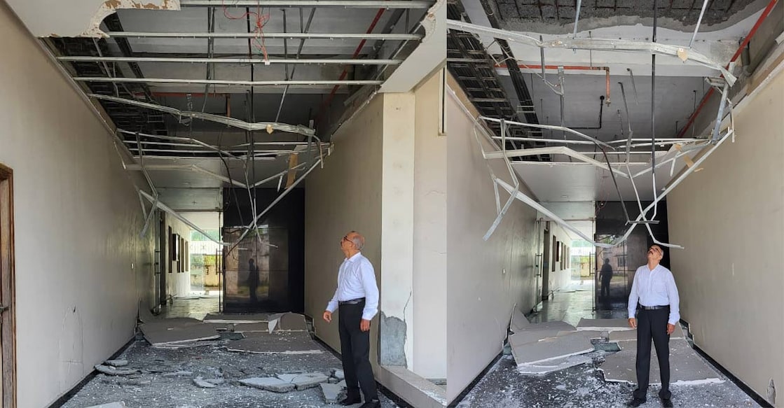 Colonel Ciby George (Retd) near the debris of the collapsed concrete ceiling at Chander Kunj towers. Photos: Special Arrangement. 