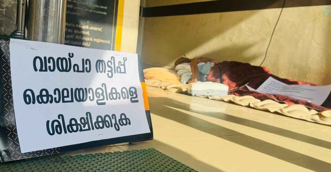 Sreedharan Nair, 95, lying in front of the bank He was later shifted to hospital as his condition worsened. Photo: Special arrangement