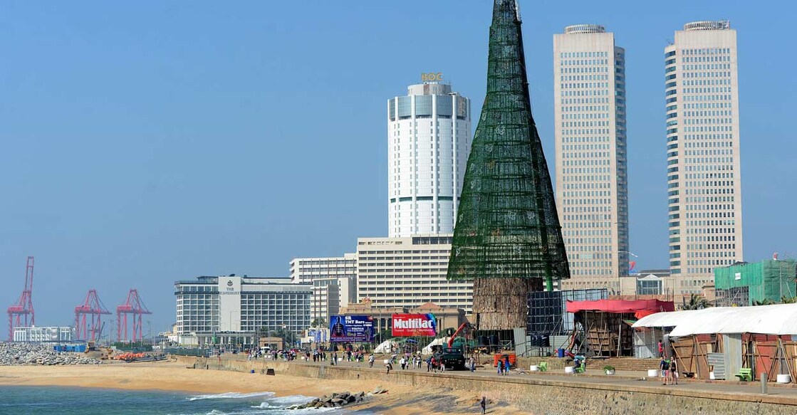 Pedestrians walking past a partially-constructed Christmas tree in Colombo. File photo: Lakruwan Wanniarachchi/AFP