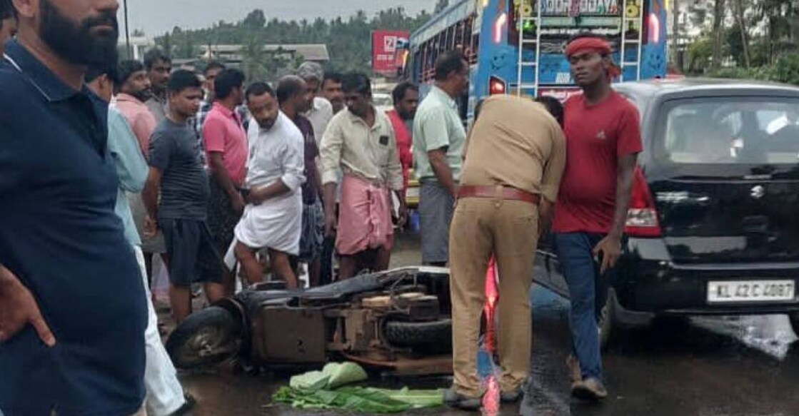 Police at the site of the fatal bus–scooter collision on State Highway 34 in Kozhikode. Photo: Special Arrangement