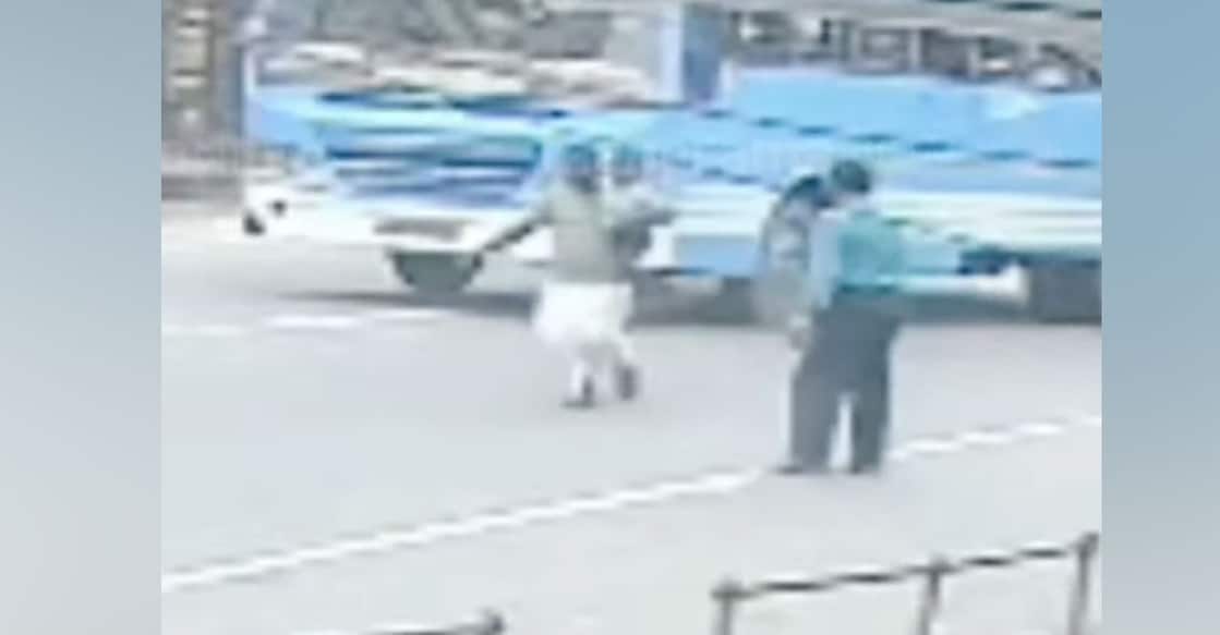 CCTV visuals showed the man jumping underneath the bus with his child. Photo: Screengrab/Manorama News