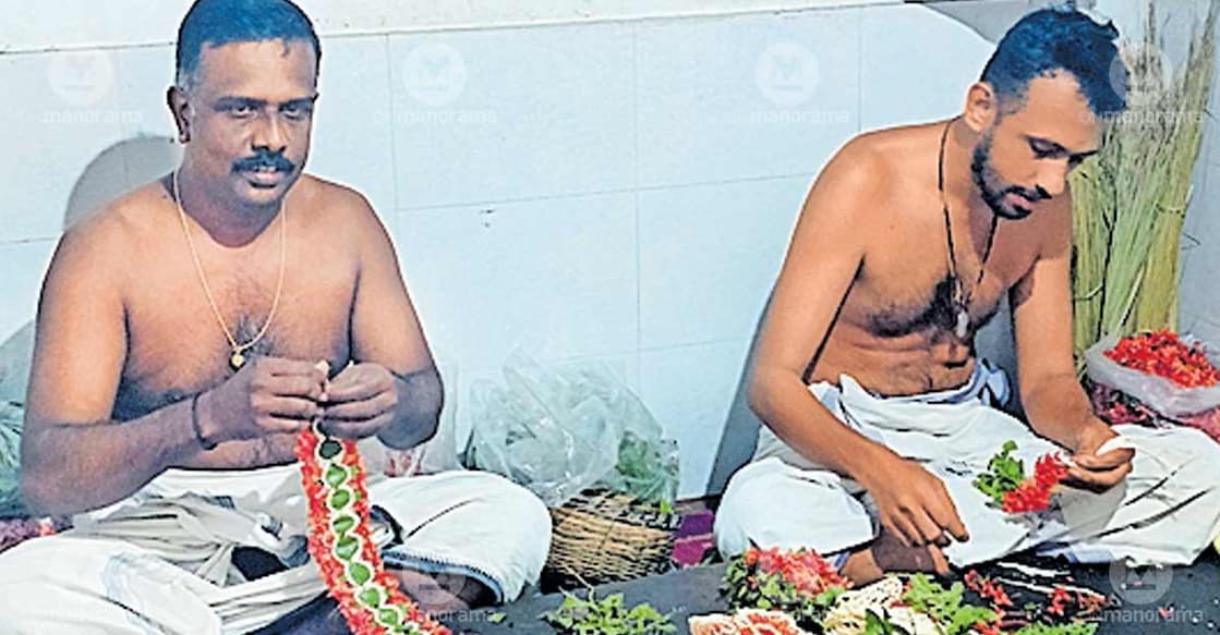 V Gireesh Kumar (L) and M V Sivaprasad on duty at the temple. Photo: Special arrangement