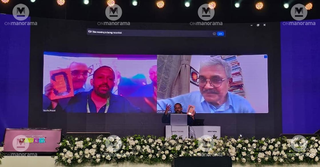 Writer S Anand sat alone, while the face of renowned scholar and activist Anand Teltumbde looked down from a large screen behind him. Photo: Manorama. 