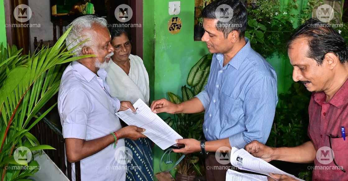 Chief Electoral Officer Rathan U Kelkar distributes SIR enumeration form to a voter. Photo: Manorama Archives