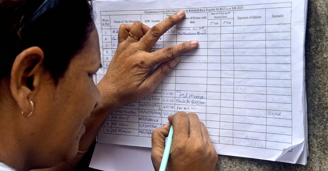 A voter fills enumeration form as part of SIR process. Photo: PTI