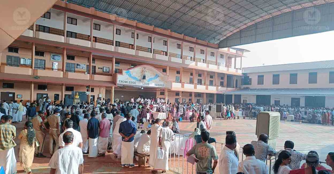 People wait in front of the vote-counting centre at Athirampuzha St Aloysius School. Photo: Manorama