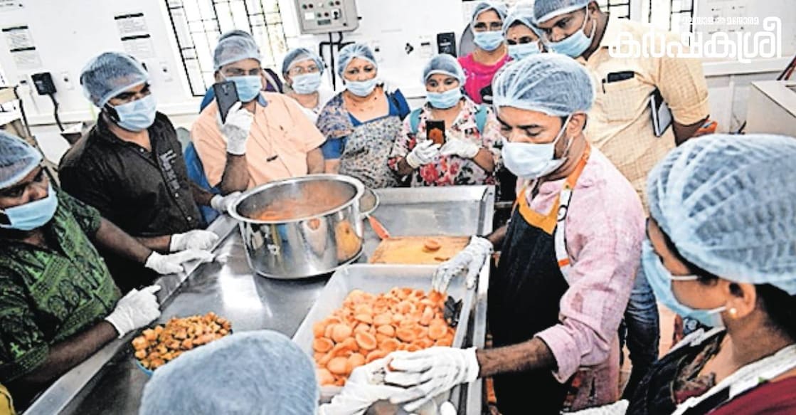 Dinesh giving training in nutmeg-rind processing. Photo: Manorama Online