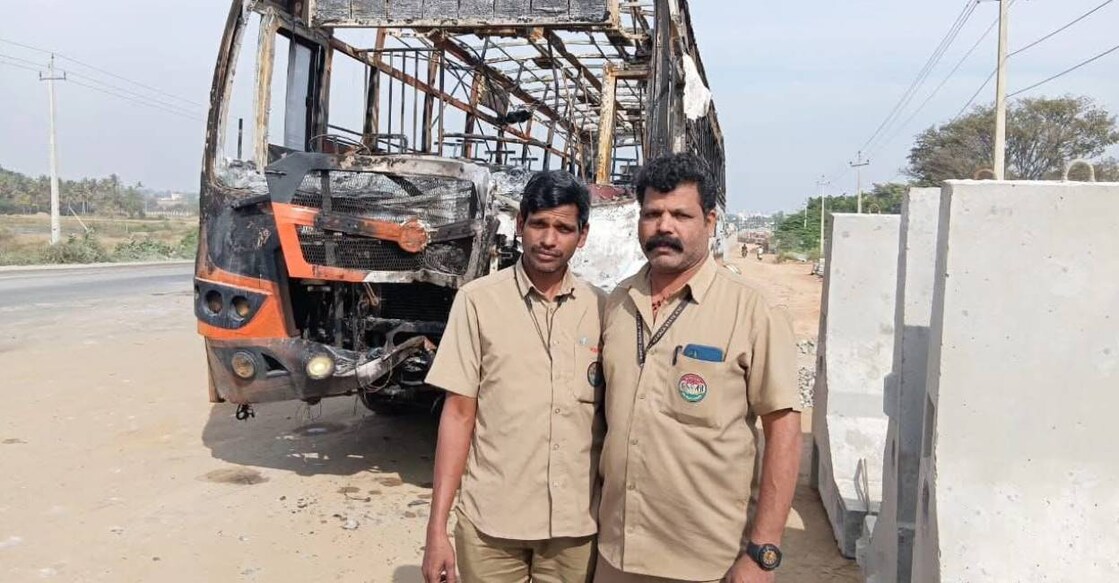 Sidheeqali (L) and Sajeevan (R) in front of the bus which caught fire near Nanjangud, Mysore,  Karnataka. Photo: Special Arrangement