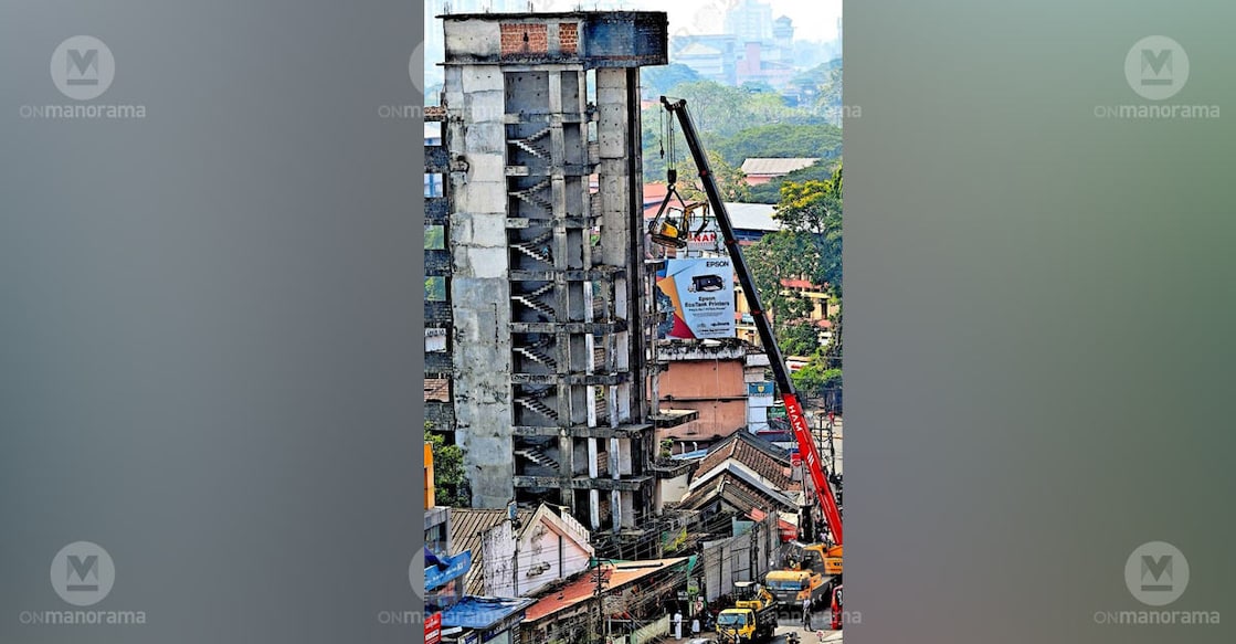 A hydraulic breaker is being lifted to the top of the 10-storey building near the Kannur Collectorate using a heavy crane as part of the demolition process. Photo: Special arrangement