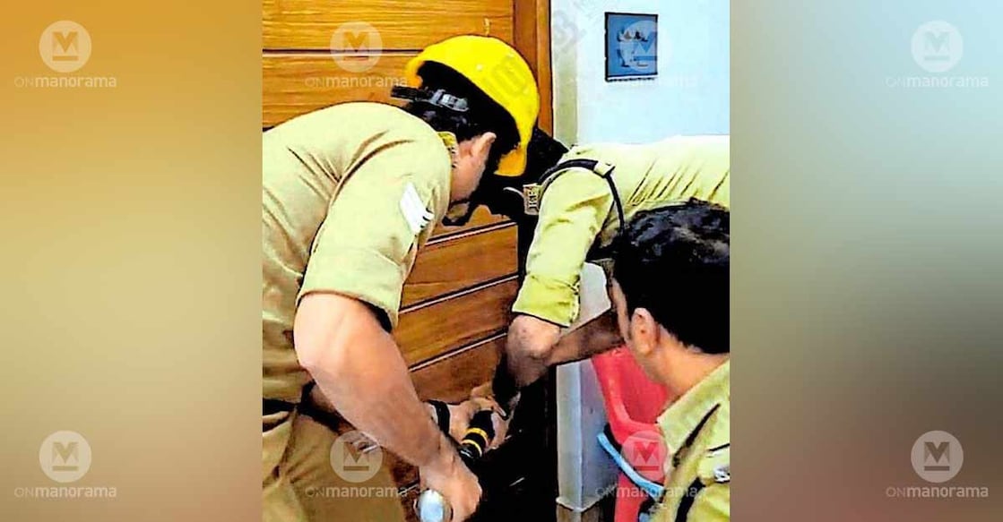 Fire Force personnel trying to open the door. Photo: Special arrangement