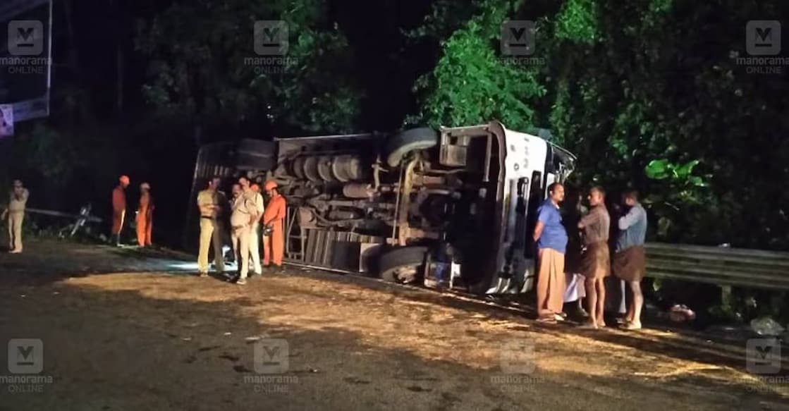 The tourist bus overturned in Pala, Kottayam. Photo: Manorama