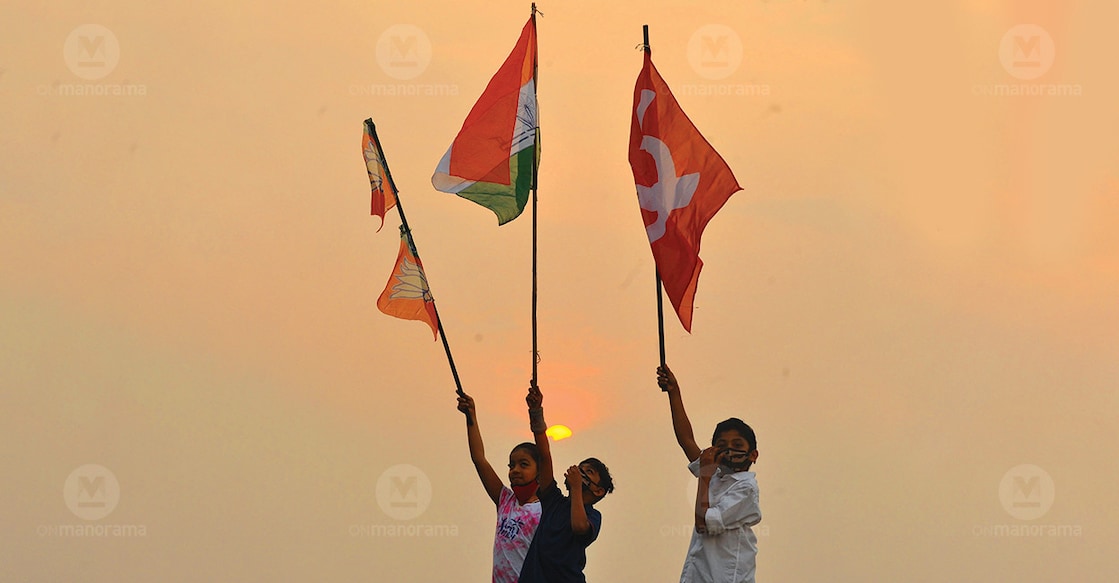 Three children wave flags of three political parties- BJP, Congress, CPM- in the air. File Photo: Manorama