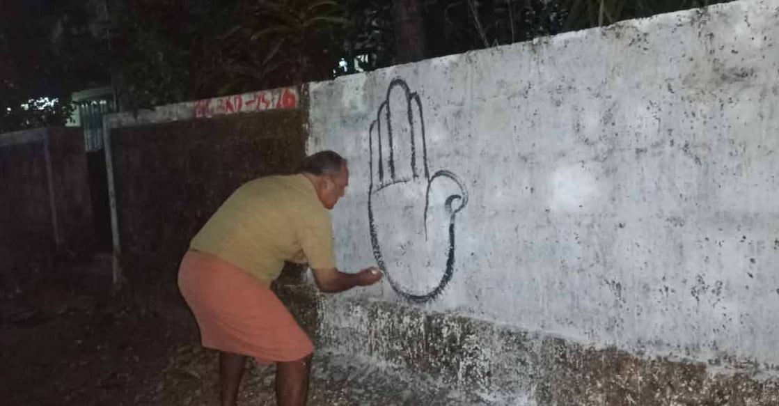 Kumar drawing a hand symbol on a wall. Photo: Special arrangement