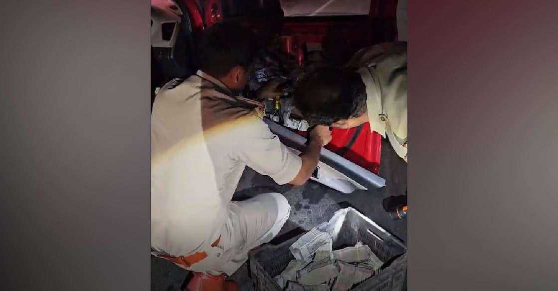 Police seize cash from hidden compartments of the vehicle. Photo: Special Arrangement