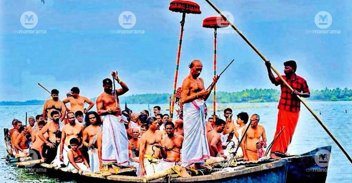 The oracles crossing the Kavvayi Lake on a wooden raft held together by two country boats during the fourth day of the annual Pattulsavam at the Koyankara Payyakkal Bhagavati Temple in Thrikkarippur. Photo: Special arrangement
