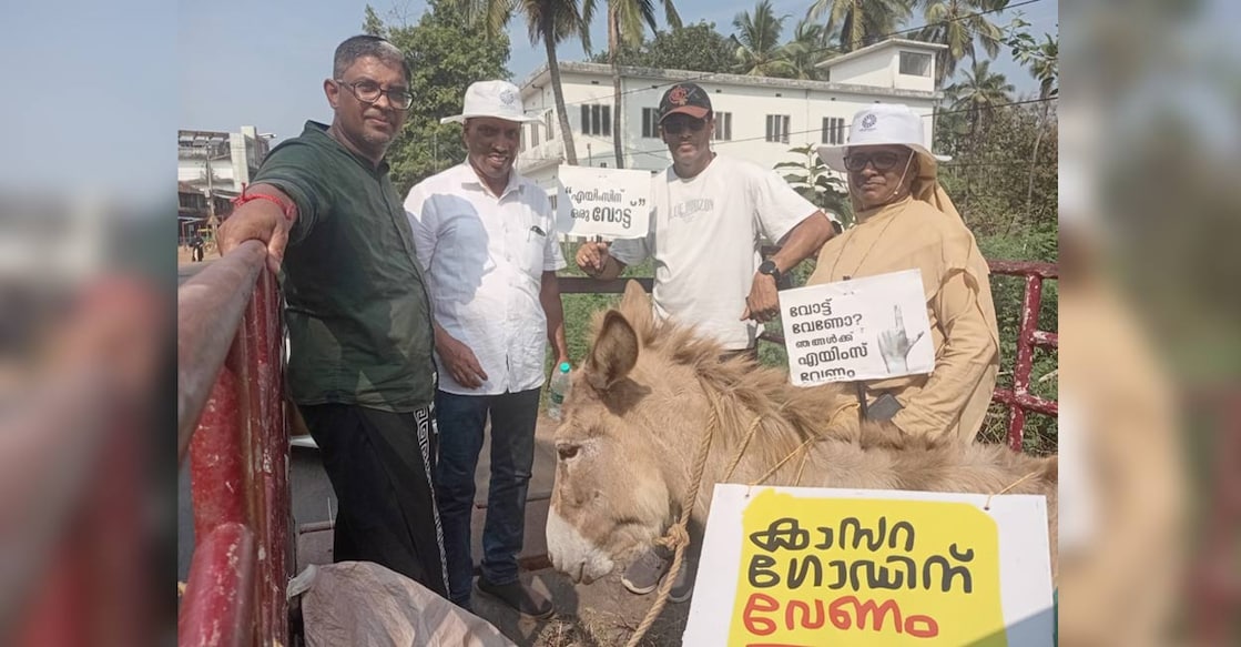The AIIMS Kasaragod People’s Collective set out from the New Bus Stand in Kasaragod, walking the 26 km stretch to Kanhangad with a donkey riding ahead on a mini-truck, a placard strapped to it reading: Kasaragod needs AIIMS. Photo: Special Arrangement. 