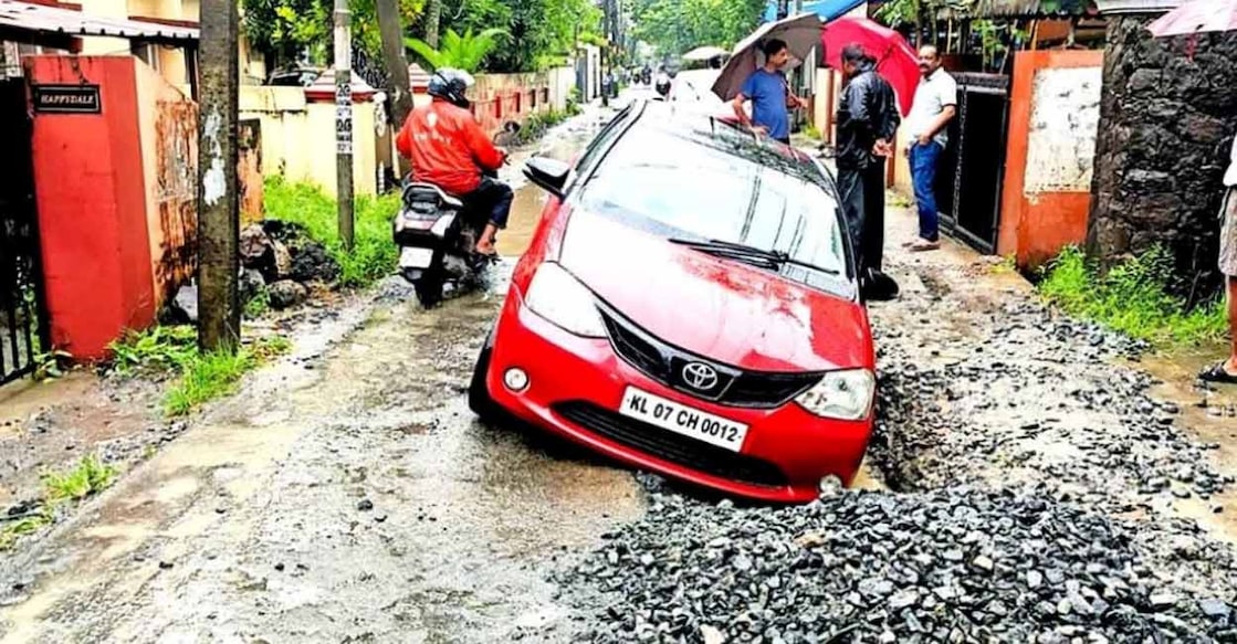 panampiily-road-c When a car fell into a pothole on Panampilly Nagar-Thevara road. Photo: Special arrangement