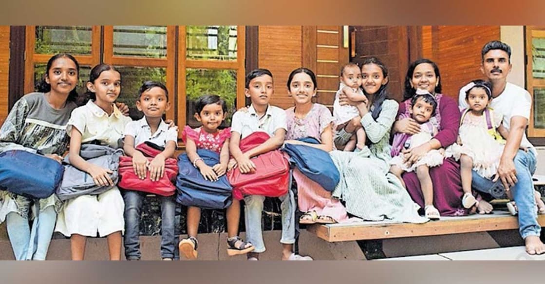 P J Santosh wife Ramya and ten children P J Santosh with his wife Ramya and children in front of their house. Photo: Special arrangement