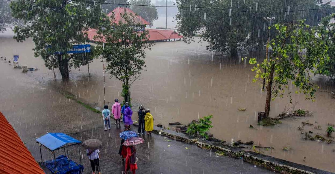 Pedestrians look on as the water level of the Periyar river increased following heavy rainfall, at Aluva in Ernakulam district of Kerala, Thursday, June 26, 2025. Photo: PTI