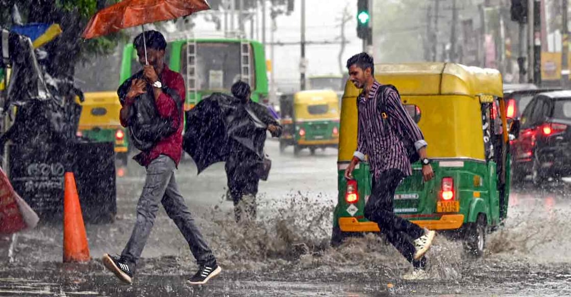 People cross a road amid heavy rain in Thiruvananthapuram, Thursday, June 26, 2025. Photo: PTI