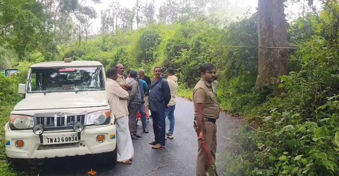 Police and locals near the spot where the body was found. Photo: Manorama