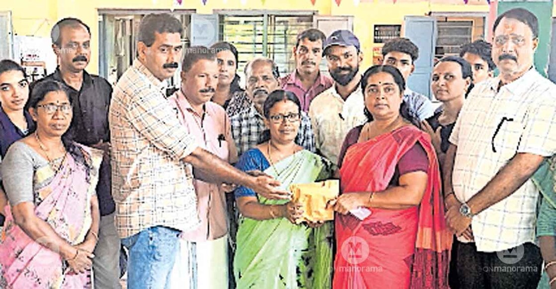 Balla Government Higher Secondary School Principal CV Arvaindakshan and headmistress MS Subha Lakshmi handing over the donation collected towards the treatment of Akshath Mon to Kanhangad municipal chairperson KV Sujatha. Photo: Special arrangement