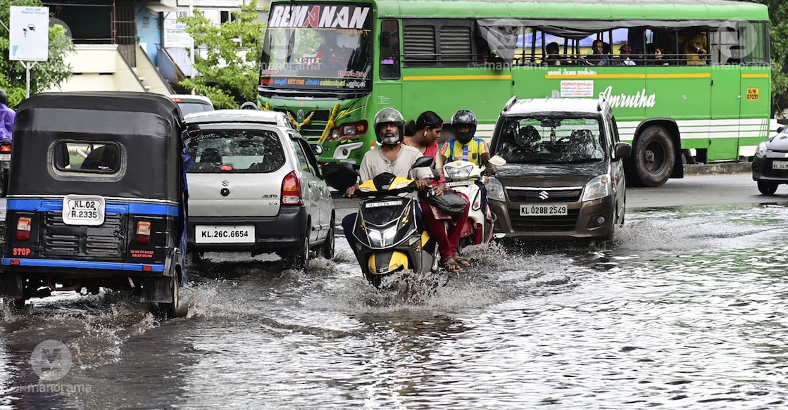 kerala rain A man navigates through a waterlogged road in Kerala. Photo: Rinku Raj Mattancheriyil/Manorama
