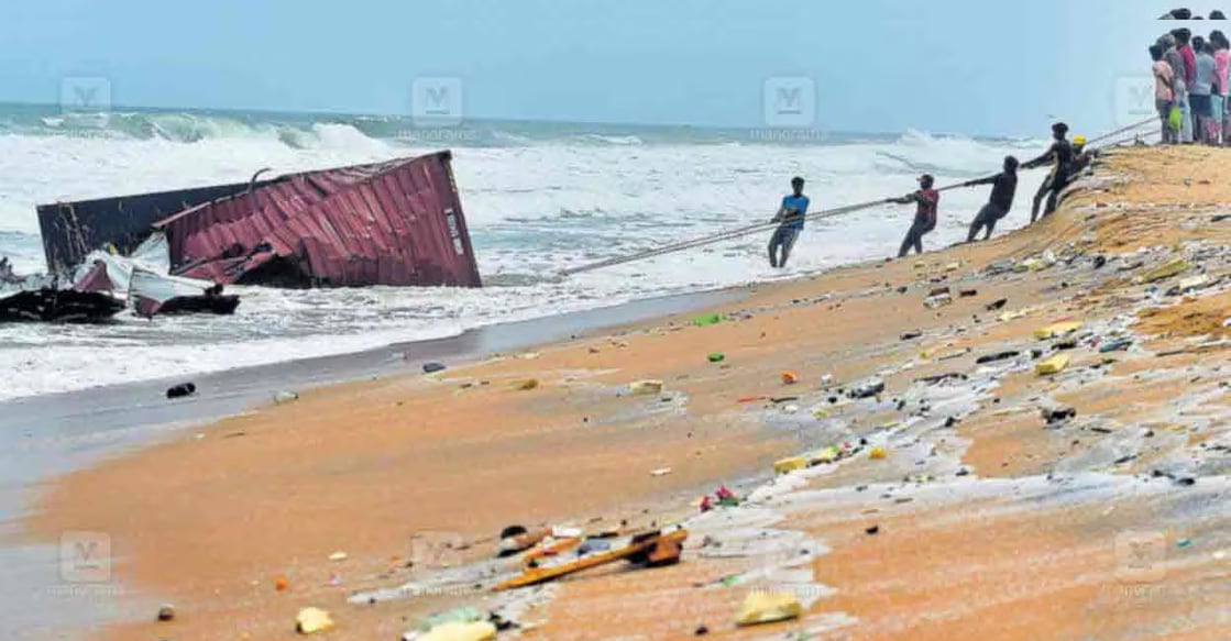 Fire and rescue teams and local residents pulling a stranded container ashore at Pozhikkara beach, Poovar. Several polypropylene sacks inside had burst, spilling materials along the shore. Photo: Aravind Bala / Manorama