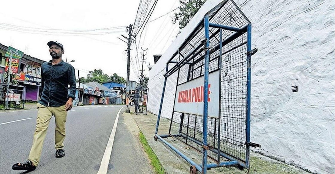 Police barricades obstructing the walkway near the Pathanamthitta Collectorate, forcing pedestrians onto the road.