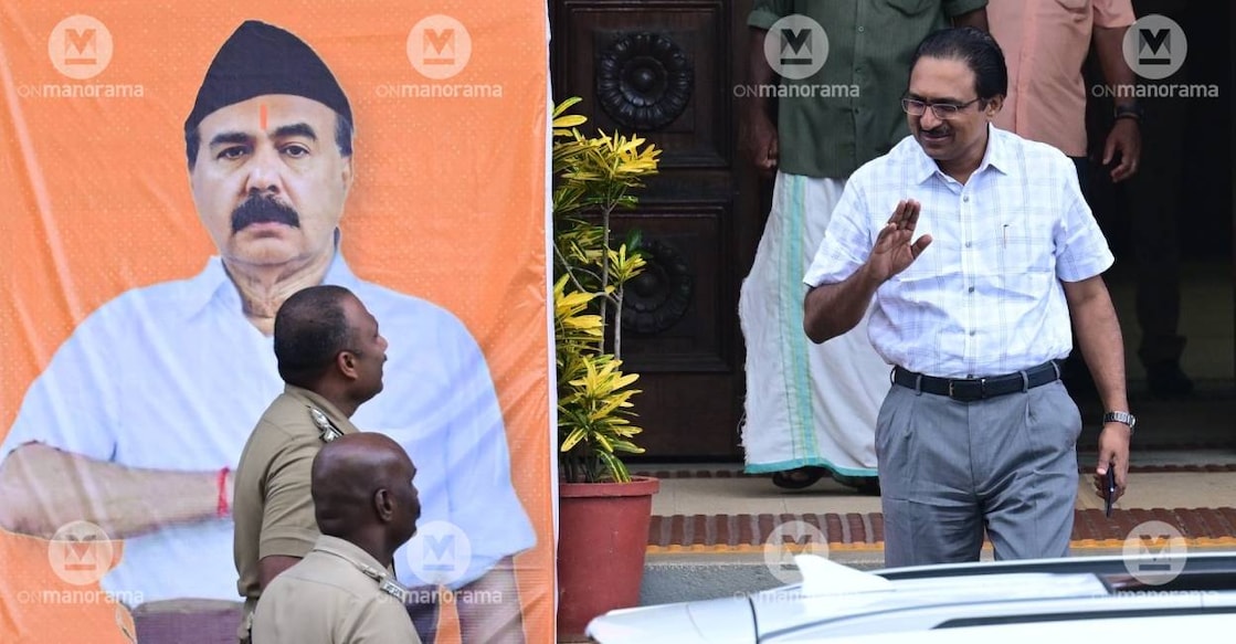 Kerala University registrar Anil Kumar leaves from his office in Kerala University. A poster placed by SFI featuring Vice Chancellor as an RSS activist is also seen. Photo: Manorama 