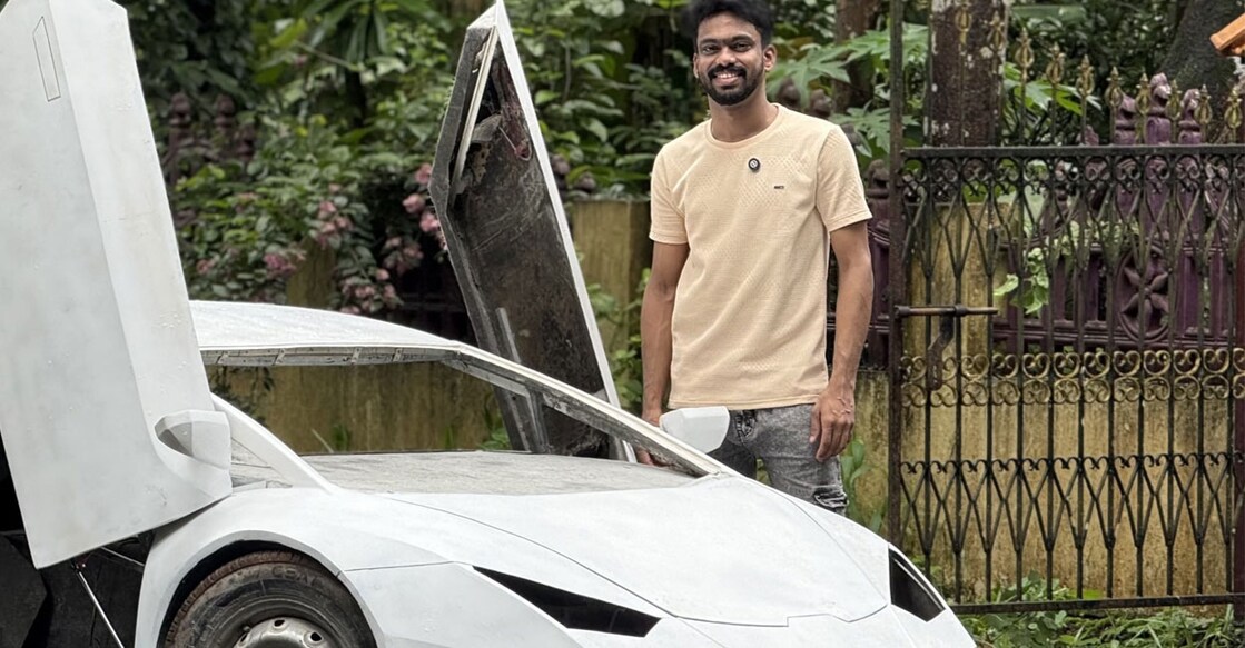 Bibin Chacko (26) with the car he is building. Photo: Special Arrangement