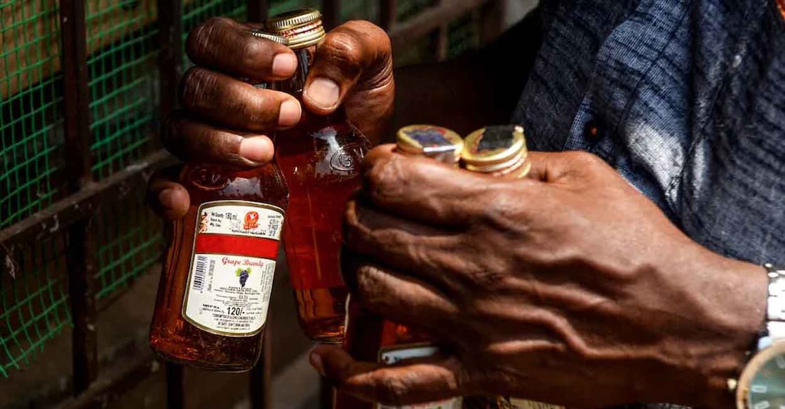 Man buying liquor from a liquor outlet. File photo: AFP