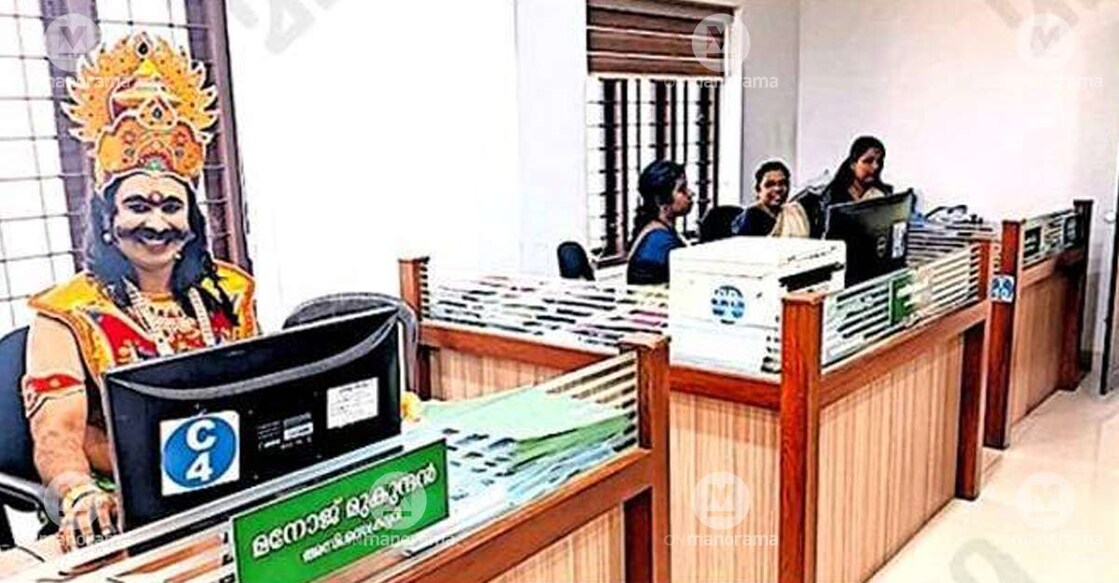Manoj Mukundan, Assistant Secretary of Mooriyad Panchayat, attending to official duties while donning the attire of Mahabali. Photo: Special arrangement