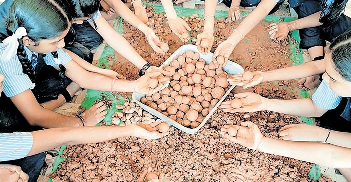 Students of Peratta St Joseph’s School making the seedballs.. Photo: Special arrangement