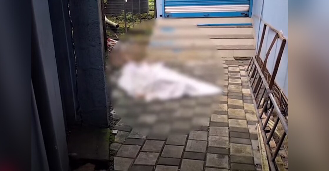 The body of an unidentified man recovered near a lodge in Perumbavoor. Photo: Screengrab/Manorama News.