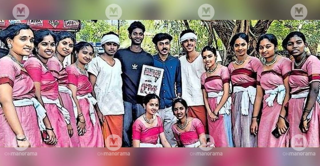Students of Chattanchaal Higher Secondary School, Kasaragod, who performed Irula Nritham at the State School Kalolsavam, present a photo frame to their trainer and Attappadi Community Theatre member Sajeesh Chandran (in black T-shirt). Photo: Manorama.