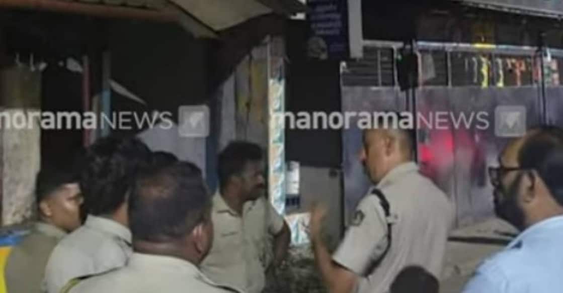 Police and people gathered in front of the house where a couple was hacked to death in Ottappalam, Palakkad. Photo: Manorama News