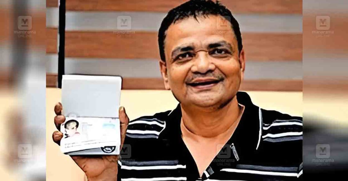 Mohammad Tanveer Alam with his son Abdur Rahman Tanveer's passport. Photo: Manorama