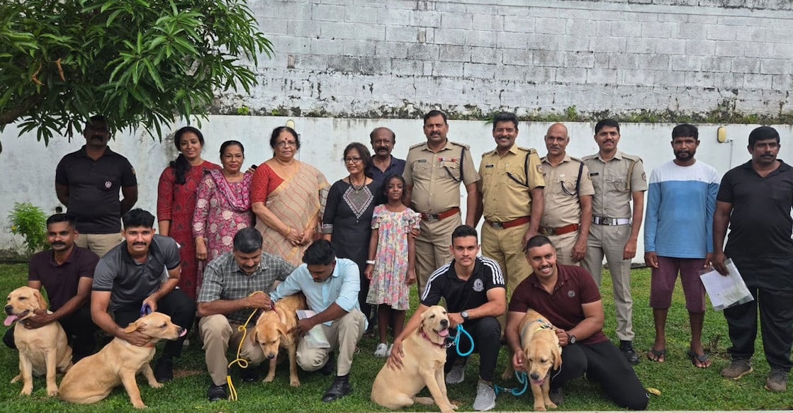 The Labrador puppies with the Kerala police team at Jaleela's residence. Photo: Special Arrangement
