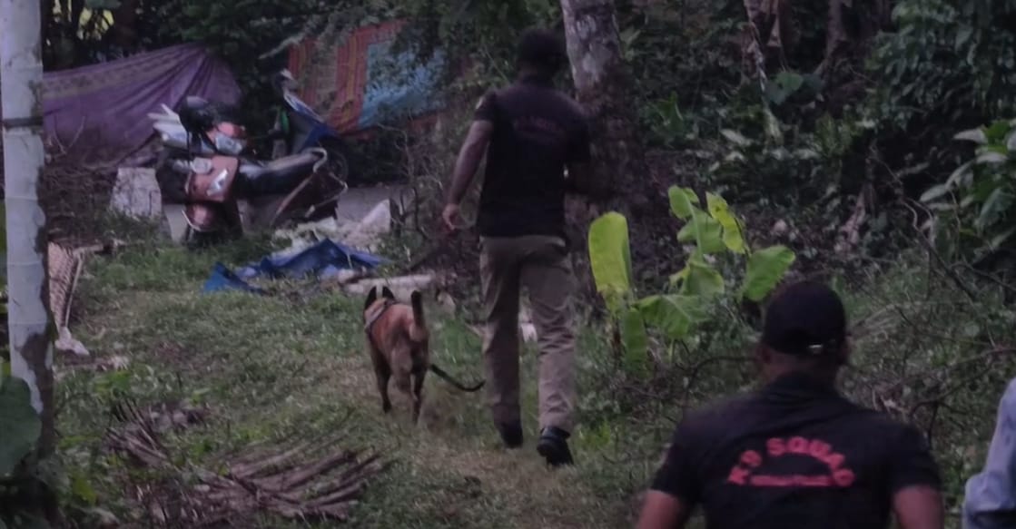 Dog squad conducting searches at the house where the woman was found dead in Karalam. Photo: Special arrangement