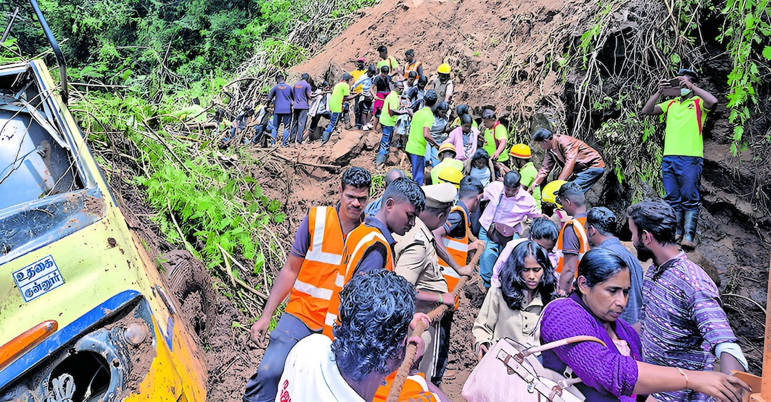 Rescue workers move students of Buchanan Girls High School in Pallom, Kottayam, after a landslide brought down soil onto a bus at Burliar on the Ooty National Highway. Photo: Malayala Manorama
