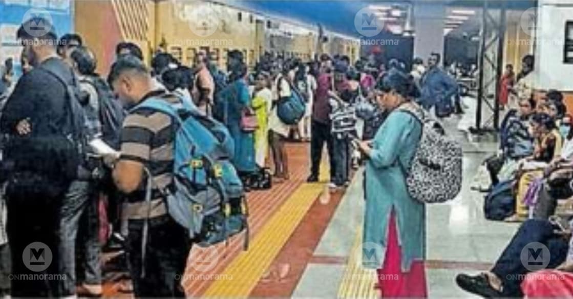 Passengers wait outside the locked doors of the Chennai Egmore Express at Guruvayur Railway Station. Photo: Special Arrangement. 