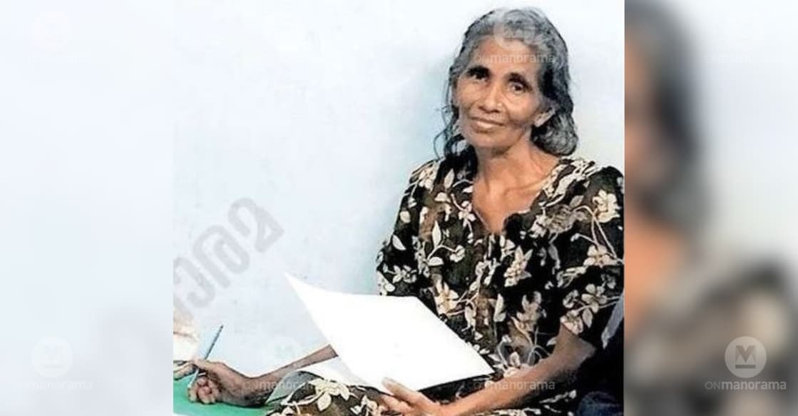 Usha, who is undergoing treatment at Pariyaram Government Medical College Hospital along with her two sons, tries to write her name on a sheet of paper given by healthcare workers. Photo: Special Arrangement.