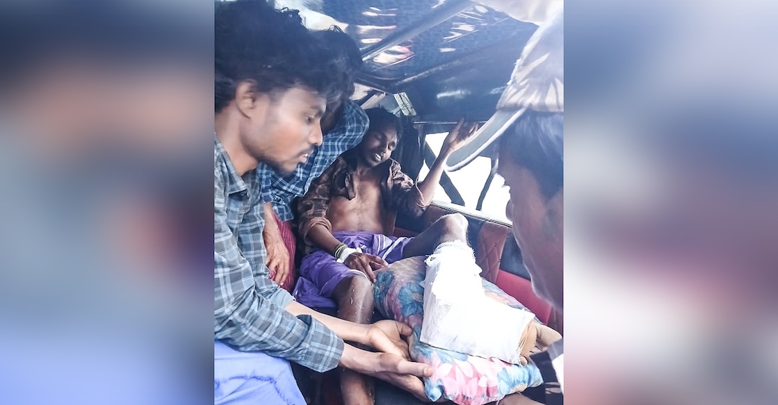 Kaliraj, who was injured in a gaur attack, is being taken to a hospital by local residents. Photo: Special Arrangement.