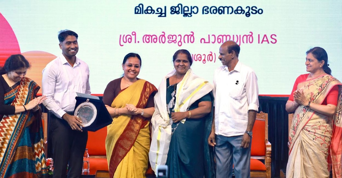 Health Minister Veena George shares the stage with Thrissur District Collector Arjun Pandian, his mother Ushakumari S and his father Pandian C. Photo: Special Arrangement