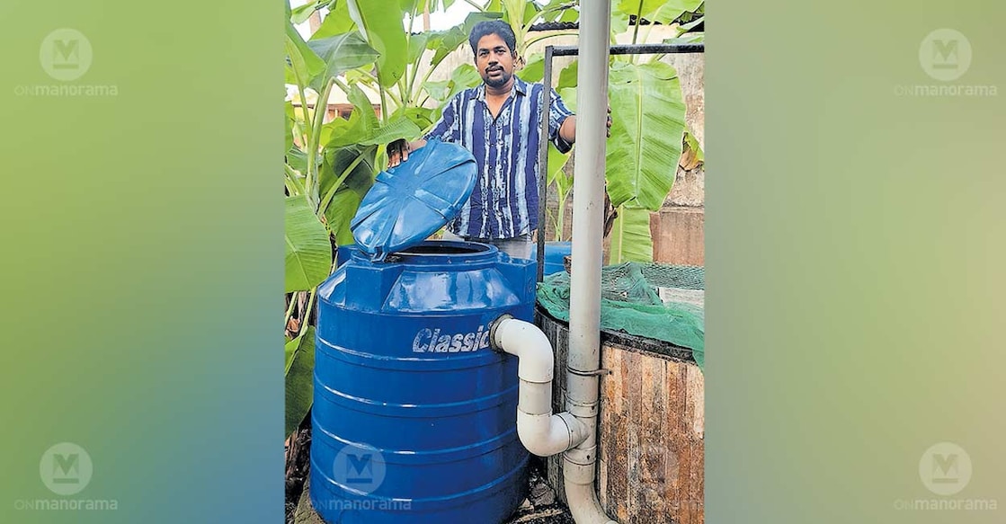 P V Vinod stands beside a filtration tank that channels rainwater into the well. Photo: Special arrangement