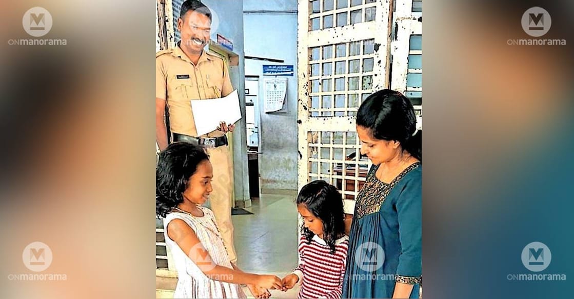 Jewel Bibin returning the gold chain she found by the roadside to its owner.