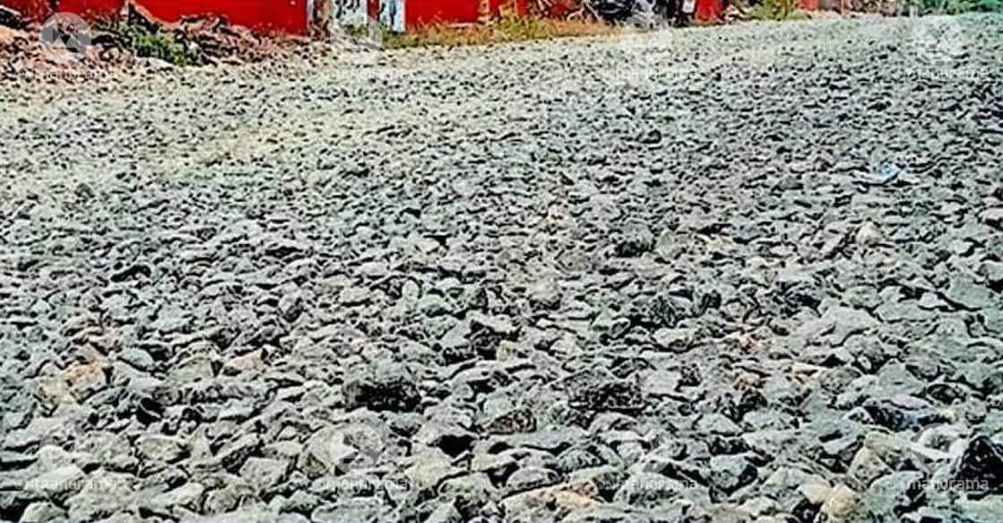 Vehicles and pedestrians are struggling to move through as huge metal stones are paved on the road after removing the layer of tar. Photo: Special arrangement